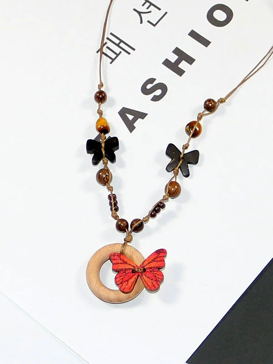 Collier femme en perles artistiques avec papillon en bois