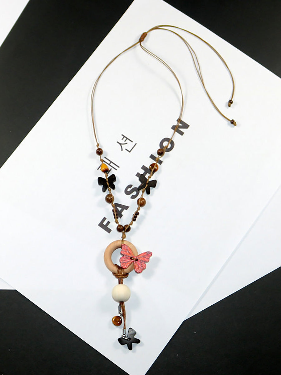 Collier femme en perles artistiques avec papillon en bois