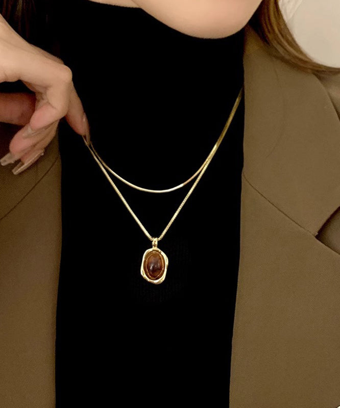 Ensemble de colliers et pendentifs en cuivre, ambre et or, style surdoré