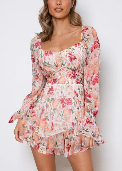 Combinaison rose élégante à imprimé printanier et fermeture éclair avec dentelle