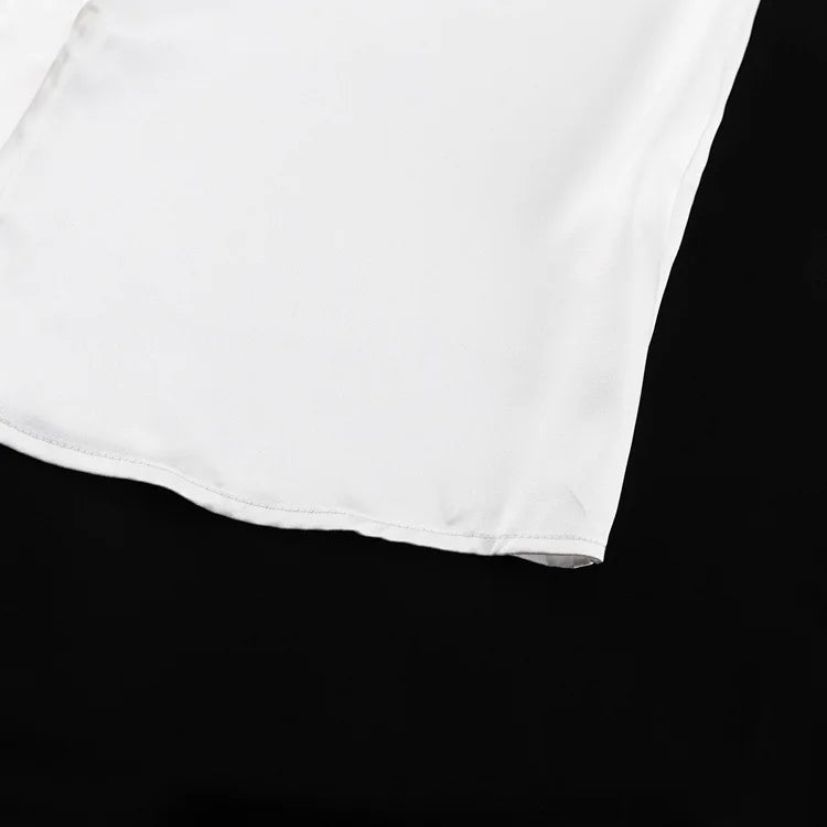 Haut en satin à manches longues et revers blanc avec nœud 